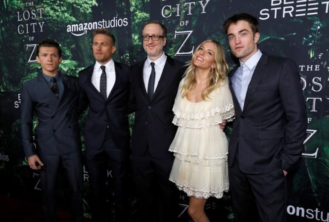 Director of the movie James Gray (C) poses with cast members (L-R) Tom Holland, Charlie Hunnam, Sienna Miller and Robert Pattinson pose at the premiere of the movie Sienna Miller poses with her