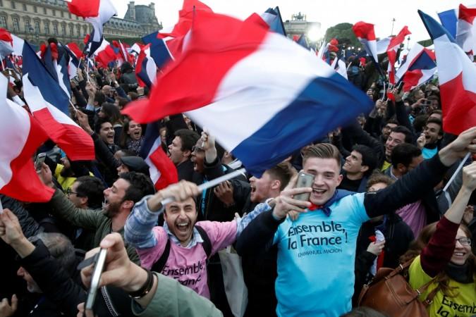 Supporters of French President Elect Emmanuel Macron celebrate near the Louvre museum after early results were announced in the second round vote in the 2017 presidential elections on May 7, 2017. Emmanuel Macron