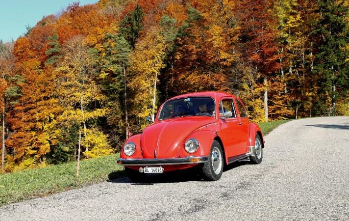A vintage Volkswagen Beetle drives through during a sunny autumn day near the village of Eptingen, Switzerland October 27, 2015 Volkswagen Beetle