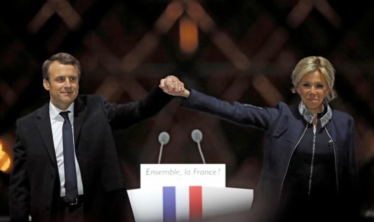 French President elect Emmanuel Macron and his wife Brigitte Trogneux celebrate May 7, 2017 on the stage at his victory rally Emmanuel Macron with wife