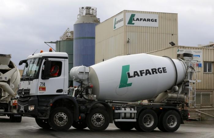 The logo of French building material Lafarge is seen on cement trucks at a production plant in Paris, France, February 22, 2016. In July 2015. lafargeholcim, acc ambuja cements merger, ultratech cement, acc share price, ambuja cements share price, ultratech cement share price