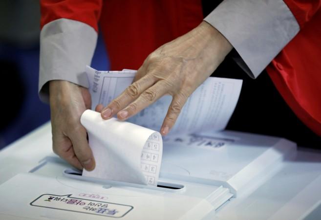 A woman casts her vote at a polling station during the presidential elections in Seoul, South Korea May 9, 2017. South Korean elections