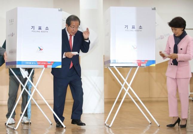 Hong Joon-pyo, the presidential candidate of the Liberty Korea Party, and his wife Lee Sun-sam walk to cast their ballots at a polling station in Seoul Hong Joon-pyo