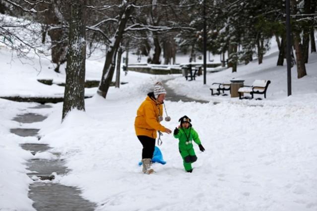 A child plays on the snow with her mother in Ankara Mother's Day, happy mother's day, mother child