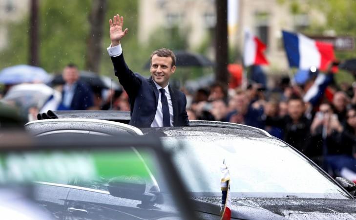 French President Emmanuel Macron waves from his car on the Champs Elysees avenue after the handover ceremony in Paris, France, May 14, 2017. Emmanuel Macron