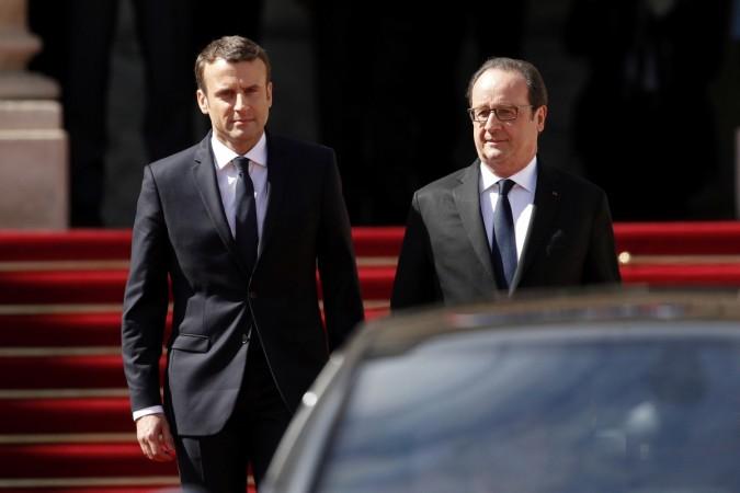 French President Emmanuel Macron (L) escorts former President Francois Hollande who leaves after the handover ceremony at the Elysee Palace in Paris, France, May 14, 2017. Emmanuel Macron