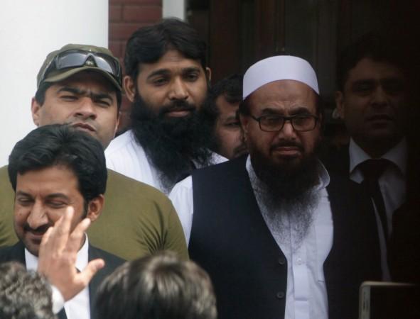 Hafiz Muhammad Saeed (R), chief of the Islamic charity organisation Jamaat-ud-Dawa (JuD), leaves after he appeared before a court to challenge his house arrest in Lahore, Pakistan, May 13, 2017. Hafiz Saeed
