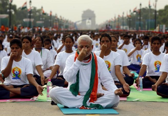 India's Prime Minister Narendra Modi performs yoga with others during a yoga camp to mark the International Day of Yoga, in New Delhi, India, June 21, 2015. Narendra Modi
