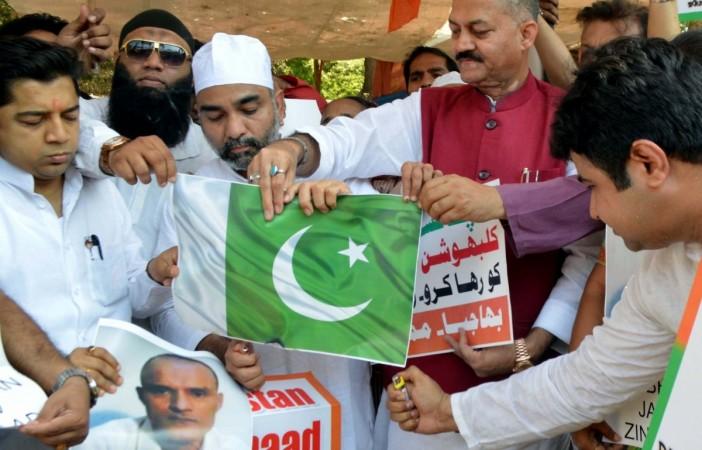People stage a demonstration after a Pakistani Field General Court Martial awarded the capital punishment to former Indian Navy officer Kulbhushan Jadhav, in Mumbai on April 12, 2017. kulbhushan jadhav, icj, icj verdict on kulbhushan jadhav, naval officer, india, harish salve, pakistan, jadhav arrested, death sentence for kulbhushan jadhav