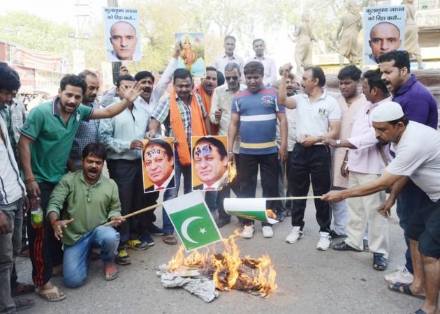 People stage a demonstration after a Pakistani Field General Court Martial awarded the capital punishment to former Indian Navy officer Kulbhushan Jadhav, in Varanasi on April 12, 2017. kulbhushan jadhav, icj, icj verdict on kulbhushan jadhav, naval officer, india, harish salve, pakistan, jadhav arrested, death sentence for kulbhushan jadhav