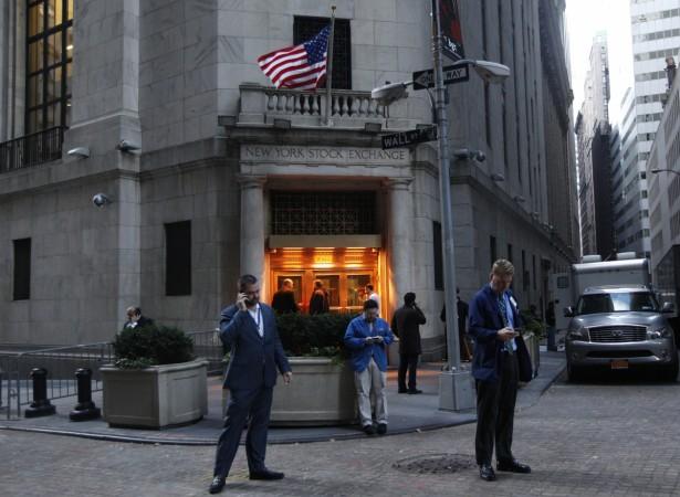 Traders stand outside the New York Stock Exchange prior to the opening bell October 31, 2012. New York Stock Exchange