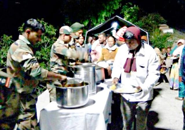 In picture: Indian Army personnel serve food at a camp set up for pilgrams stranded in Vishnuprayag due to a landslide. Indian Army camp for pilgrams stranded in Vishnuprayag