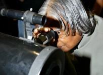 A. P. J. Abdul Kalam looks through a telescope during his visit to a Philippines school in Manila February 6, 2006. Kalam is in Philippines on a four-day long visit.