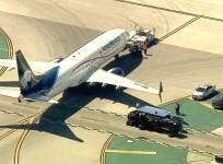 8 injured after passenger jet collides with utility truck at Los Angeles airport