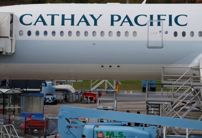 A passenger plane of Cathay Pacific Airways parks at the airport in Colomiers near Toulouse, Southwestern France, November 24, 2016 cathay pacific, job cuts at cathay pacific, global aviation in turmoil, singapore airlines weak results, radical changes in singapore airlines