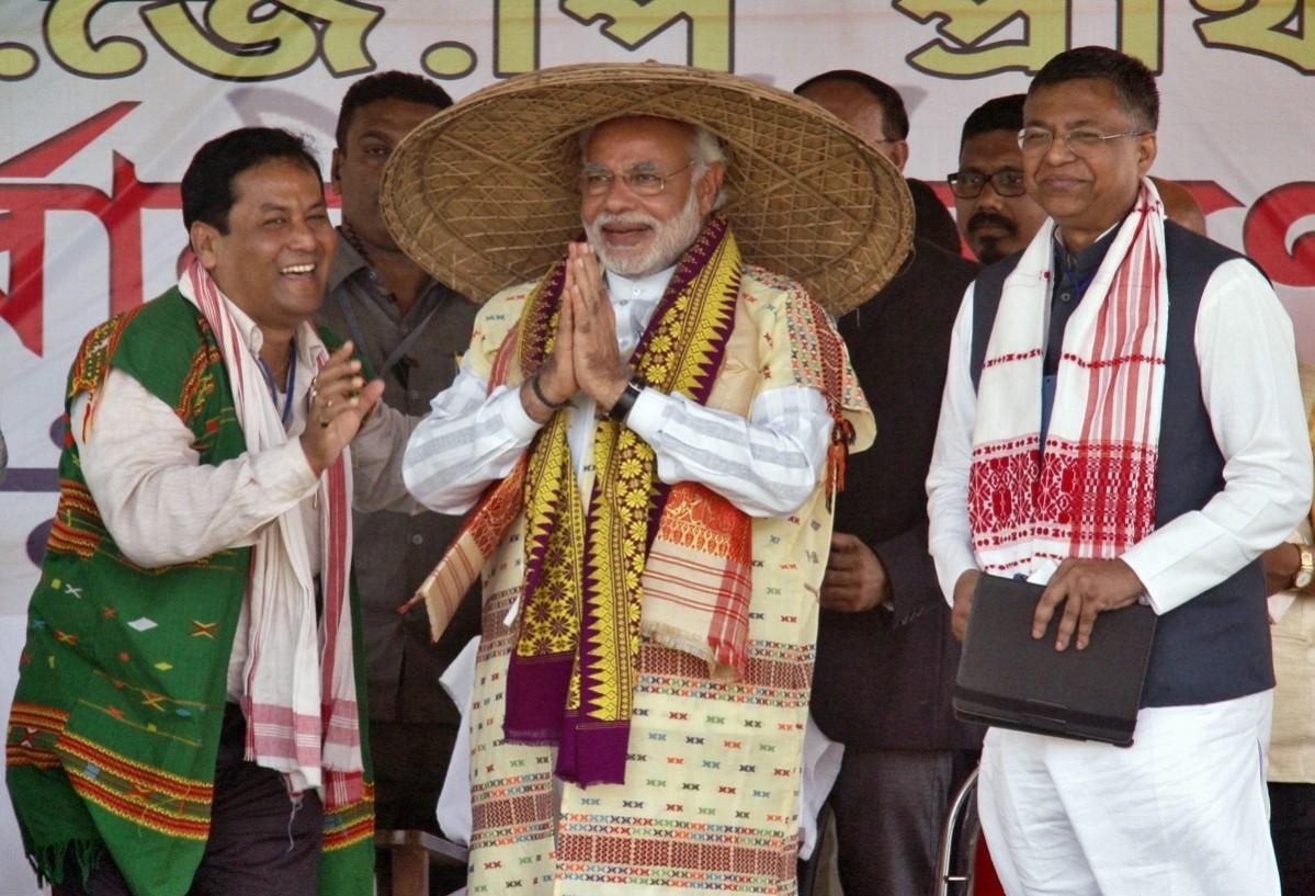 Narendra Modi dons the traditional Assamese hat called Jaapi Narendra Modi