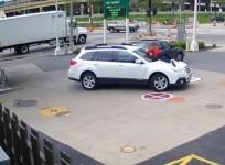 Woman foils would-be carjacker by leaping on car hood