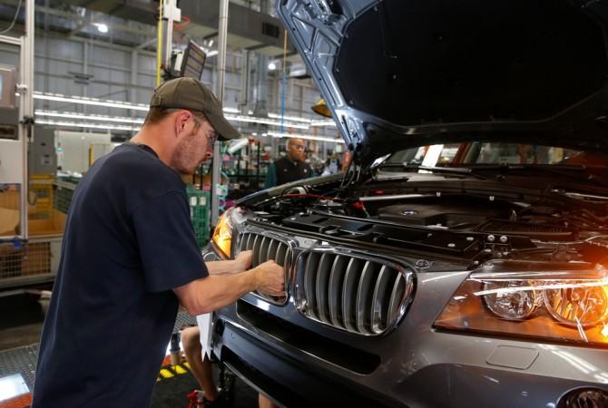A BMW employee works to install the kidney grill on an X4 along the production line at the BMW manufacturing plant in Spartanburg, South Carolina March 28, 2014. BMW plant in USA