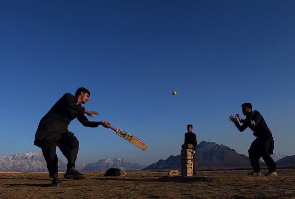 Afghan youths play cricket in a field on the outskirts of Kabul on January 7, 2017 afghanistan cricket