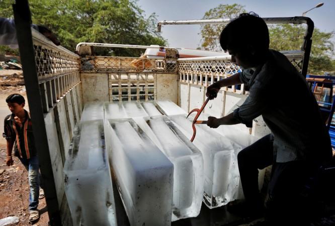 A worker of an ice factory loads an ice bar onto a truck on a hot summer day on the outskirts of Ahmedabad, India, May 13, 2016. gdp, india gdp, gdp fy18 forecast, smes, small medium enterprises, sme survey, american express survey for sme, india news, gdp forecast, gdp projection
