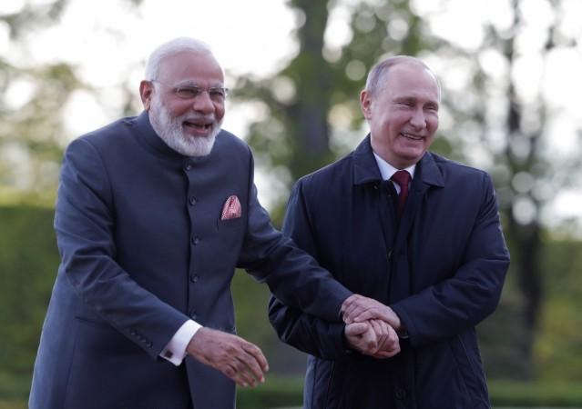 Russian President Vladimir Putin (R) and Indian Prime Minister Narendra Modi react during their meeting in St. Petersburg, Russia, June 1, 2017. Modi Putin