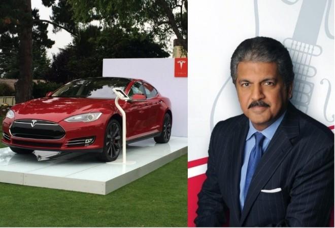 Tesla Model S on display (left), Anand Mahindra (right) Anand Mahindra and Tesla