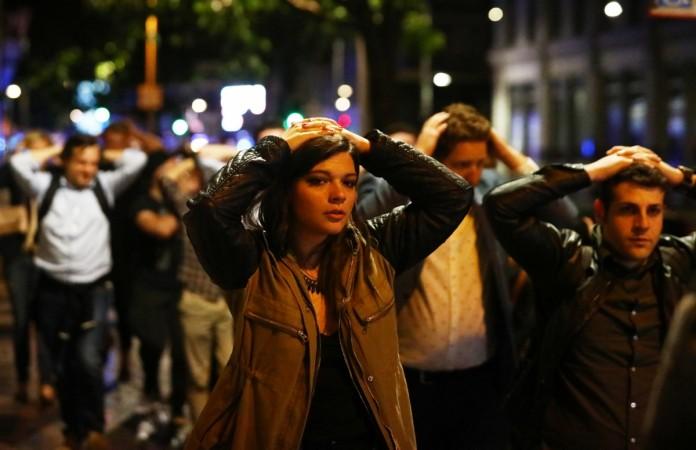 People leave the area with their hands up after an incident near London Bridge in London, Britain June 4, 2017. London Attack
