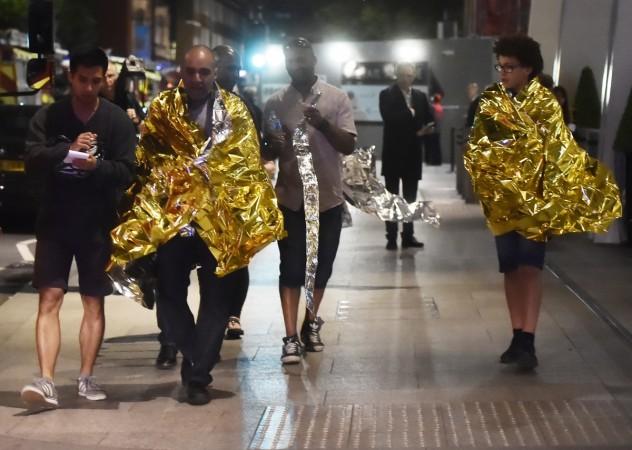 People leave the area wearing foil blankets after an incident near London Bridge in London, Britain June 4, 2017. London