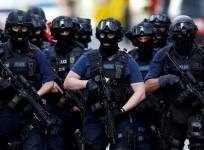 Armed police officers walk near Borough Market after the attack