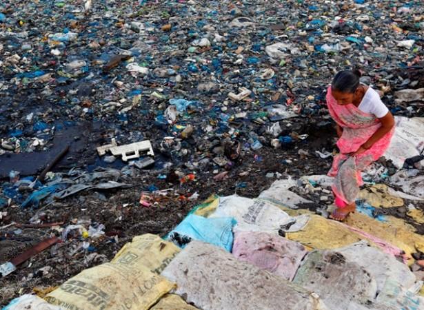 A woman crosses a polluted water canal at a slum on the World Environment Day in Mumbai, India. World Environment Day, nature shocking photos