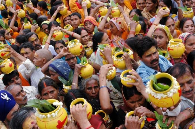 Hindu devotees carry earthen pots filled with sacred water to offer to the Hindu god of destruction, Lord Shiva, during a religious festival of Nirjala Ekadashi in the northern Indian city of Varanasi June 14, 2008. Hindu devotees carry earthen pots filled with sacred water to offer to the Hindu god of destruction, Lord Shiva, during a religious festival of Nirjala Ekadashi in the northern Indian city of Varanasi