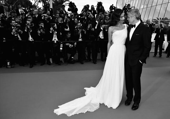 US actor George Clooney (R), and his wife British-Lebanese lawyer Amal Clooney pose on May 12, 2016, as they arrive for the screening of the film 'Money Monster' at the 69th Cannes Film Festival in Cannes, southern France. George Clooney and wife Amal