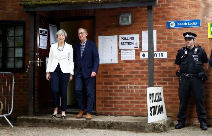Britain's Primer Minister Theresa May and her husband Philip leave a polling station in Sonning, Britain. Theresa May