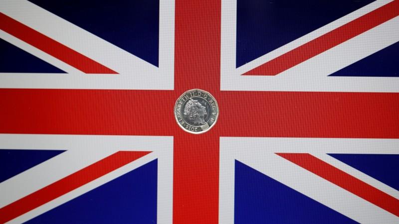A one pound coin lies on a Union Flag in a photo illustration shot May 3, 2017. uk elections, uk election results, britain result, britain election, theresa may, brexit
