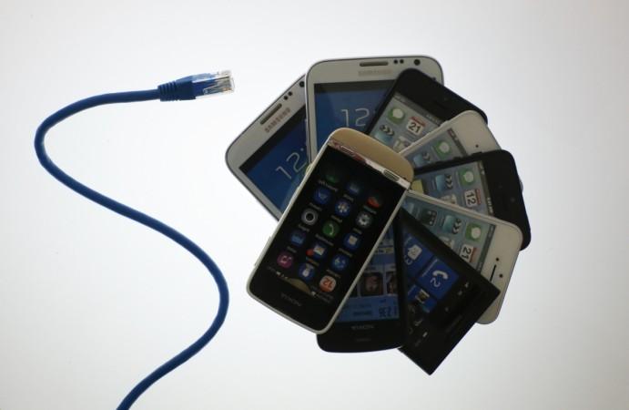 An illustration picture shows a network cable next to a pack of smartphones in Berlin, June 7, 2013. The debate over whether the U.S. government is violating citizens' privacy rights while trying to protect them from terrorism escalated dramatically on Thursday amid reports that authorities have collected data on millions of phone users and tapped into servers at nine internet companies. An illustration picture shows a network cable next to a pack of smartphones in Berlin