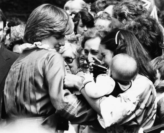 Lady Diana Spencer, the fiance of Prince Charles, holding a baby as she greets the crowds of onlookers, during the opening of the Mountbatten Exhibition at Broadlands, Romsey, Hampshire, May 9th 1981. Princess Diana