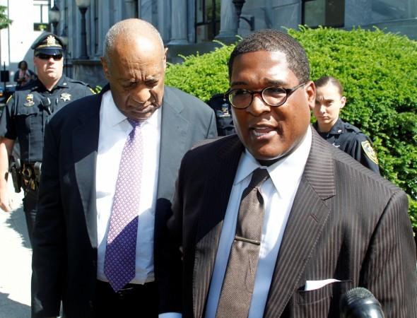 Actor and comedian Bill Cosby waits as his publicist Andrew Wyatt answers a reporter's question while they depart after the fifth day of his sexual assault trial at the Montgomery County Courthouse in Norristown, Pennsylvania. Bill Cosby