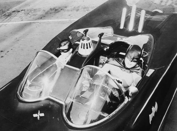 American actors Burt Ward (left), as Robin, and Adam West, as Batman, ride in the Batmobile in a still from the television series, 'Batman,' c. 1967. Adam West as Batman