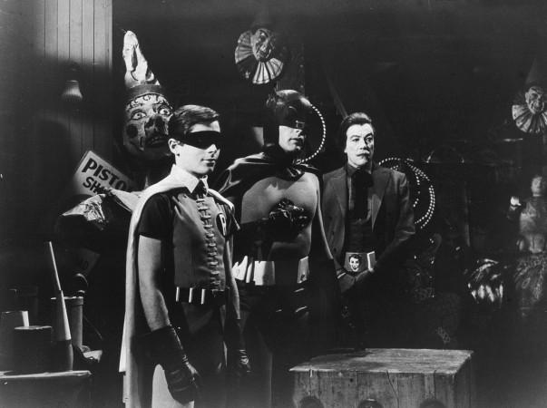 L-R: American actors Burt Ward, as Robin, Adam West, as Batman, and Cesar Romero (1907 - 1994), as The Joker, stand in a room with circus props in a still from the television series, 'Batman,' c. 1967. Adam West