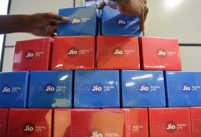An employee arranges a display for JioFi devices at a Reliance Digital store in Mumbai on April 21, 2017. Reliance Jio