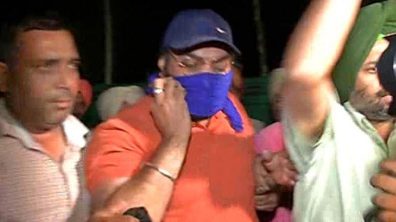 In picture: Inderjit Singh (centre) being taken into custody. Inderjit Singh