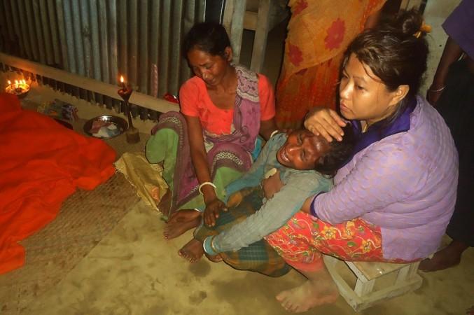 A Bangladeshi woman mourns next to bodies of relatives (not pictured) after a landslide in Bandarban on June 13, 2017. Bangladesh Landslide
