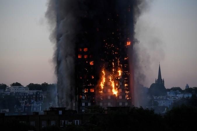 Flames and smoke billow as firefighters deal with a serious fire in a tower block at Latimer Road in West London, Britain June 14, 2017. London Fire