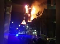 Video shows onlookers staring at burning tower in London