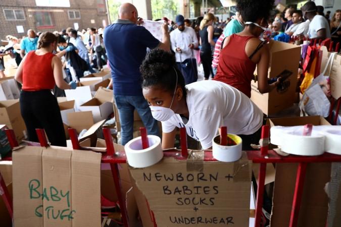 In picture: Volunteers organise donated supplies near the scene of a fire disaster that destroyed a tower block, in north Kensington, West London, Britain June 15, 2017. London fire