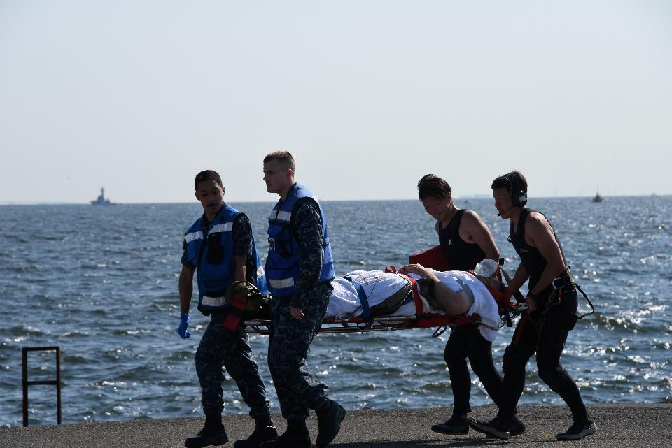 An injured crew member of the Arleigh Burke-class guided-missile destroyer USS Fitzgerald, damaged after colliding with a Philippine-flagged merchant vessel, is carried on a stretcher after arriving at the U. S. naval base in Yokosuka, south of Tokyo, Japan June 17, 2017. An injured crew member of the Arleigh Burke-class guided-missile destroyer USS Fitzgerald, damaged after colliding with a Philippine-flagged merchant vessel, is carried on a stretcher after arriving at the U. S. naval base in Yokosuka, south of Tokyo, Jap