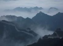 Early morning fog covers the Jiankou section of the Great Wall, located in Huairou District, north of Beijing, China. At one of the most treacherous and least restored stretches of China's Great Wall, a line of pack mules halted upon emerging from the glo