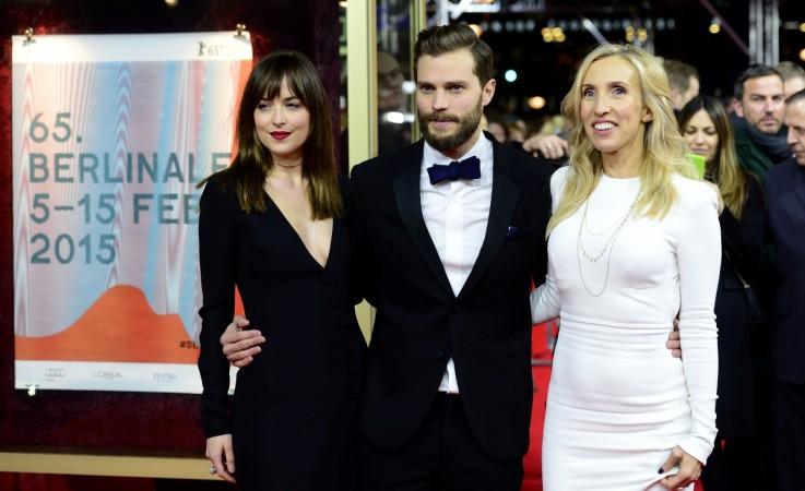 US actress Dakota Johnson, US actor Jamie Dornan, British director Sam Taylor-Johnson pose for photographers on the red carpet as they arrive for the screening of Fifty 'Shades of Grey' as part of Berlinale Special Gala at the 65th Berlin International Film Festival Berlinale in Berlin, on February 11, 2015. Dakota Johnson, Jamie Dornan, director Sam Taylor-Johnson