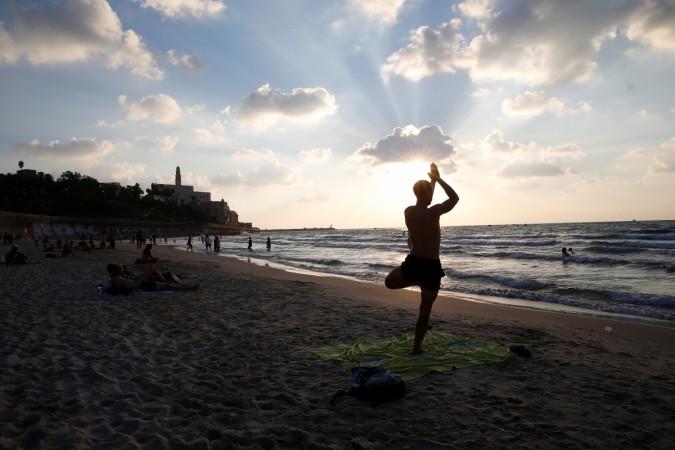 A man performs yoga on a beach on the Mediterranean coast in Tel Aviv, Israel. International Yoga Day, Yoga Day, Yoga Day 2017, Yoga quotes