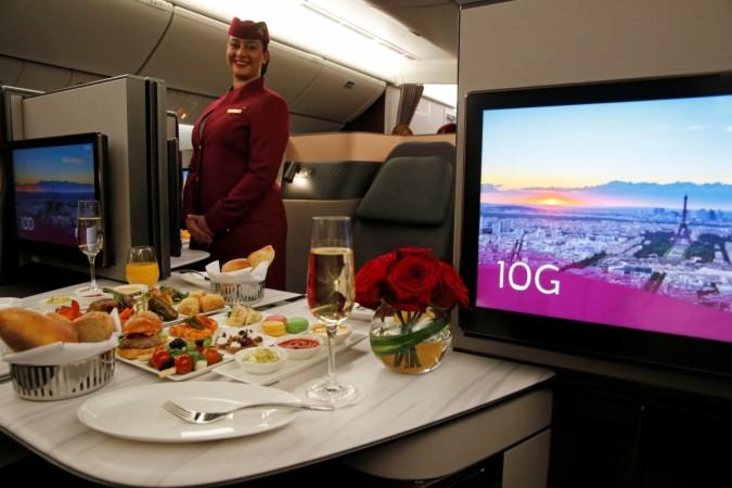 A Qatar Airways crew member presents the business class seats of a Boeing 777 aircraft during the 52nd Paris Air Show at Le Bourget airport near Paris, France, June 19, 2017. Qatar Airways